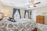 Another view of the primary bedroom highlights its impressive depth and generous size.