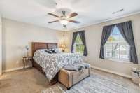 The spacious primary bedroom boasts a walk-in closet and an ensuite bathroom.