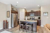 Enjoy a morning cup of coffee or an evening glass of wine with friends at the inviting kitchen island. All Stainless steel appliances including refrigerator to remain with home.