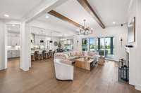 Wooden beams and recessed lighting add character and depth to the design. For the ultimate indoor-outdoor experience, simply slide open the doors to the screened-in porch and let the fresh air in.