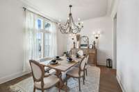 The spacious formal dining room, located just off the foyer, seamlessly connects to the kitchen through an extended Butler’s pantry, creating the perfect flow for entertaining.