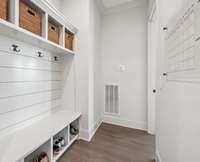 Located just off the hallway near the garage, the mudroom area offers a practical drop zone with easy backyard access through the rear foyer door.