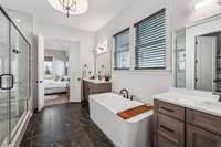 Thoughtful elements include separate vanities with quartz countertops, oil-rubbed bronze faucets, and a walk-in closet with built-in shelving and drawers, ensuring a seamless morning routine.