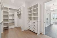 Don’t miss the spacious walk-in closet featuring wood shelving and built-in drawers for optimal organization.