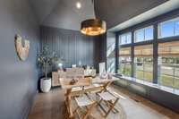 The office exudes sophistication with judges paneling, elegant accent paint, and large windows with transoms that flood the space with natural light