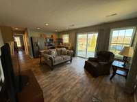 Open living room and eat in kitchen in apartment.