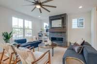 The open-concept layout seamlessly connects to the kitchen and dining area, making it the perfect space for gatherings, entertaining, or cozy nights in.