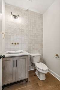 Half bathe with floor to ceiling accent tile wall