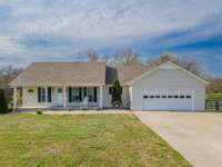 Large garage and concrete driveway with enough parking for guests or large family.