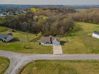 .85 acre +- goes with this property.  Line goes into the woods behind home.  The very nice fence has wire behind the wooden fence, so pets cannot get out of this portion of your back lawn.