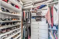 Primary closet is set up for maximized storage and organization
