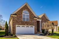 This full brick beauty with stamped concrete driveway is full of upgrades!