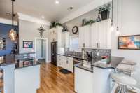 This gorgeous white kitchen with black granite counter tops includes cabinet space galore!