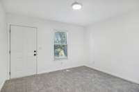 Main floor bonus living area backing up to the 5th bedroom. Has a separate entrance to the back deck.