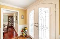 Sunlit castle-like entry doors within the foyer.