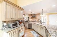 The island is extra long with built in microwave, dishwasher & cook book alcove.