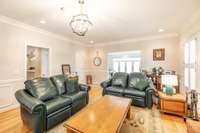 The left entryway returns to the kitchen from the living room, & the right archway steps down to the game room/ recreation room.