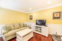 The formal living room/ parlor is opposite the formal dining room off the foyer entryway. It is currently used as a TV room. Historically in many homes there have been optional uses for this parlor space such as a home office.