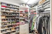 Main level owners suite walk-in closet.  Custom organization shelving and clothing space.