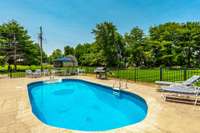 In-ground saltwater pool, surrounded by stamped concrete.. A spacious outdoor living space for gatherings & soaking up the sun..