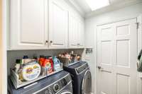 The laundry room is within a hallway upon entering from the garage. The perfect location to drop any dirty clothing on your way into the house after planting and gardening.   The washer and dryer do not remain with the sale.