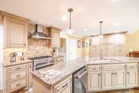 Beautiful bronze & clear glass pendant lighting above the island.