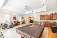 The enormous recreation room has a tile floor boarded by natural oak flooring. Custom cabinetry and wet bar was added by the current owner. The surround sound speakers in the ceiling were never in use by the owner. Unknown why they do not function.