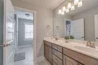 Upstairs guest bath with double vanities and a tub/shower combination.