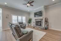 Living room has a gas fireplace and lots of natural light.