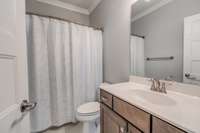 Main level guest bathroom with a tub/shower combination.