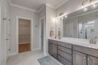 The owner's suite bathroom offers double vanities, linen closet, tiled shower, and a toilet room.