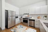 The U-shaped kitchen is fully applianced with great counter space & storage; open to main living area.