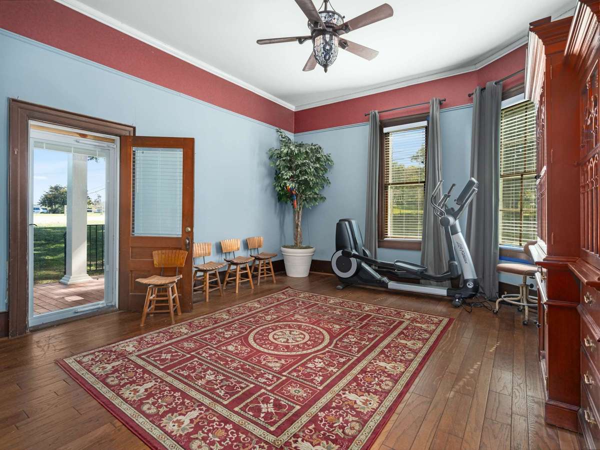 Downstairs bedroom - has exterior door onto back porch, original plaster walls, tall ceilings and so much natural light. There are so many ways to use this space.