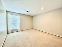 Large Guest Bedroom Suite with carpet and window view of the private courtyard