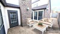 A section of the fenced courtyard is outside of the Living Room; the fence continues around to another section of the courtyard