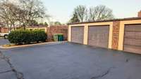 Spacious rear oversized two-car garage featuring dual garage doors for effortless parking and ample room for storage.