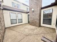 Another section of the Privately fenced courtyard view into the combination Living Room/Kitchen area;