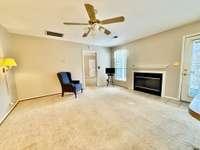 Large combination Living Room/Kitchen area with woodburning fireplace overlooking the private fenced courtyard to enjoy gardening, flowers or just relaxing