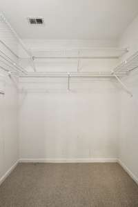 Spacious walk-in primary closet.