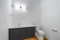 Upstairs powder room near the theater room with floating vanity. Mirror to be selected by the buyer.