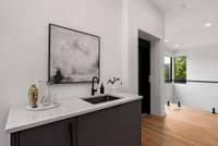Wet bar with ice maker conveniently placed between the living room and the conversation area.