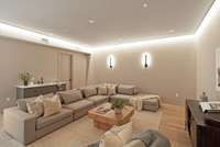The theater room includes a wet bar and two accessible storage closets as well as a full size refrigerator hookup.