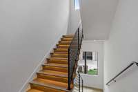 Illuminated back staircase to all levels.
