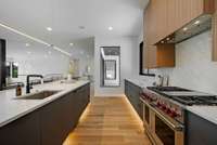 Toe kick lighting on the island and wall cabinets.