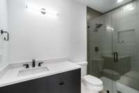 The bedroom 4 bath features a shower. Mirror to be selected.