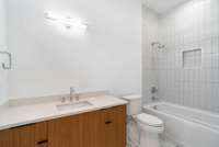 Bedroom 3 bath with tub (the photo is not true to color on the countertop)
