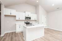 Kitchen comes adorned with Vanguard Carrara Quartz Countertops