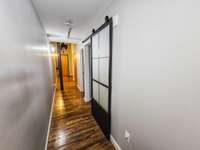 Laundry room, guest bath & downstairs BR with sliding door are all off the hall way.