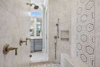 The dual entry, walkthorugh shower with custom tile work and fixtures.