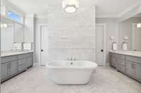 Stand alone tub with double vanities and closets